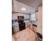 Cozy kitchen features wood-look floors, granite counters, stainless steel appliances, and ample cabinet space at 768 E Michigan St # 75, Orlando, FL 32806