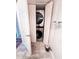Functional laundry area with a stacked washer and dryer concealed behind white folding doors for convenience and space-saving at 768 E Michigan St # 75, Orlando, FL 32806