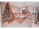 Cozy living room featuring a large tree and a neutral-toned sofa with an ottoman at 768 E Michigan St # 75, Orlando, FL 32806