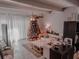 Inviting living space decorated with tree and a cozy sofa arrangement, enhancing the room's warmth at 768 E Michigan St # 75, Orlando, FL 32806