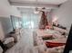 Bright living room showcasing a comfortable sofa, media console, and decorative tree by sheer curtains at 768 E Michigan St # 75, Orlando, FL 32806