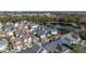 Aerial view of the house and surrounding neighborhood with a pond at 836 Lake Evalyn Dr, Celebration, FL 34747