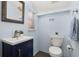 Small modern bathroom with navy vanity and white fixtures at 836 Lake Evalyn Dr, Celebration, FL 34747