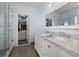 Elegant bathroom with double vanity, large mirror and walk-in shower at 836 Lake Evalyn Dr, Celebration, FL 34747