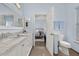 Modern bathroom with double sinks, marble countertops and separate toilet area at 836 Lake Evalyn Dr, Celebration, FL 34747