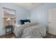 Cozy bedroom with a white bed frame, blue pillows, and wood flooring at 836 Lake Evalyn Dr, Celebration, FL 34747