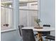 Bright breakfast nook with a marble table and four grey chairs near a window at 836 Lake Evalyn Dr, Celebration, FL 34747