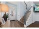 Bright entryway with wood-look floors, staircase, and stained-glass door at 836 Lake Evalyn Dr, Celebration, FL 34747