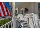 Relaxing front porch featuring rocking chairs and American flag at 836 Lake Evalyn Dr, Celebration, FL 34747
