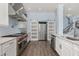 Spacious kitchen with stainless steel appliances and a farmhouse sink at 836 Lake Evalyn Dr, Celebration, FL 34747