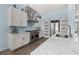 Open concept kitchen boasting stainless steel appliances and white cabinetry at 836 Lake Evalyn Dr, Celebration, FL 34747