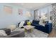 Living room with blue sectional sofa, floor lamp, and large windows at 836 Lake Evalyn Dr, Celebration, FL 34747