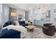 Open concept living room with blue sectional sofa and kitchen view at 836 Lake Evalyn Dr, Celebration, FL 34747