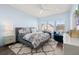 Spacious main bedroom with a large bed, seating area, and wood flooring at 836 Lake Evalyn Dr, Celebration, FL 34747