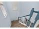 Stylish staircase with a wooden handrail and white balusters at 836 Lake Evalyn Dr, Celebration, FL 34747