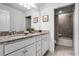 Bathroom with dual sinks, granite counters, and bathtub at 8939 Zurich Ln, Kissimmee, FL 34747