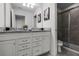 Bathroom with dual sinks, granite counters, and shower at 8939 Zurich Ln, Kissimmee, FL 34747
