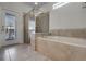 Bathroom with soaking tub, shower, and tiled floors at 8939 Zurich Ln, Kissimmee, FL 34747