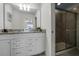 Bathroom with dual sinks, granite counters, and shower at 8939 Zurich Ln, Kissimmee, FL 34747