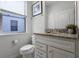 Small bathroom with toilet and granite vanity at 8939 Zurich Ln, Kissimmee, FL 34747