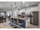Modern kitchen with granite countertops, stainless steel appliances, and an island with seating at 8939 Zurich Ln, Kissimmee, FL 34747