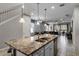 Modern kitchen with granite countertops, stainless steel appliances, and an island with seating at 8939 Zurich Ln, Kissimmee, FL 34747