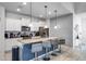 Modern kitchen with granite countertops, stainless steel appliances, and an island with seating at 8939 Zurich Ln, Kissimmee, FL 34747