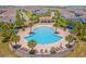 Community pool with lounge chairs and palm trees at 8939 Zurich Ln, Kissimmee, FL 34747