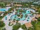 Aerial view of the resort-style pool area, including lazy river, splash pad, and amenities within a community at 8976 Azalea Sands Ln # 2604, Davenport, FL 33896