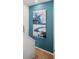 Hallway artistic wall decor with blue abstract artwork, leading to an inviting space at 8976 Azalea Sands Ln # 2604, Davenport, FL 33896