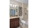 Bathroom with granite counters, shower, toilet and decorative artwork, with a clean and functional design at 8976 Azalea Sands Ln # 2604, Davenport, FL 33896