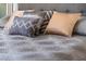 Close-up of a comfortable bed with decorative pillows and a stylish bedspread, perfect for relaxation and restful sleep at 8976 Azalea Sands Ln # 2604, Davenport, FL 33896