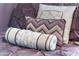 Close-up of a neatly arranged bed featuring decorative pillows and purple bedding in a comfortable bedroom at 8976 Azalea Sands Ln # 2604, Davenport, FL 33896