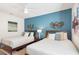 Stylish bedroom showcasing twin beds, designer wall decor, lamps and colorful accents at 8976 Azalea Sands Ln # 2604, Davenport, FL 33896