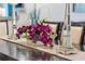 Close-up of a dining table with a decorative centerpiece and elegant mirrored candlesticks, enhancing the dining experience at 8976 Azalea Sands Ln # 2604, Davenport, FL 33896