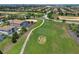 Aerial shot featuring a lush golf course with views of nearby homes, a pond, and a meticulously designed landscape at 8976 Azalea Sands Ln # 2604, Davenport, FL 33896