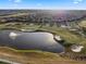 Expansive aerial shot showcasing the golf course with a serene lake and fountain amidst well-maintained greens and bunkers at 8976 Azalea Sands Ln # 2604, Davenport, FL 33896