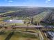 Panoramic aerial view featuring golf course, pond with fountain, and highway in a Primary-planned residential community at 8976 Azalea Sands Ln # 2604, Davenport, FL 33896