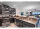 Modern kitchen featuring granite countertops, stainless steel appliances, and dark cabinetry at 8976 Azalea Sands Ln # 2604, Davenport, FL 33896