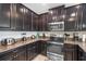 Modern kitchen features granite countertops and sleek dark wood cabinetry at 8976 Azalea Sands Ln # 2604, Davenport, FL 33896