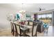 Open-concept living and dining area with modern decor, tile flooring, and large windows leading to a screened-in patio at 8976 Azalea Sands Ln # 2604, Davenport, FL 33896