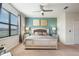 Serene main bedroom with a plush bed, elegant bedside tables, and plenty of natural light from the large window at 8976 Azalea Sands Ln # 2604, Davenport, FL 33896