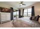 Comfortable main bedroom with ceiling fan, television, outside patio access, and view of the golf course at 8976 Azalea Sands Ln # 2604, Davenport, FL 33896