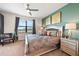 Well-lit bedroom boasting a stylish bed, matching nightstands, and large windows with views of the surrounding neighborhood at 8976 Azalea Sands Ln # 2604, Davenport, FL 33896