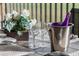 Elegant patio table setting with flowers, glassware, and a wine bucket creates a refined outdoor dining experience at 8976 Azalea Sands Ln # 2604, Davenport, FL 33896
