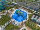 Aerial shot of colorful splash pad with interactive features, lounge chairs, and lush landscaping near the parking area at 8976 Azalea Sands Ln # 2604, Davenport, FL 33896