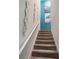 Carpeted staircase adorned with decorative mirrors leading to the upper level at 8976 Azalea Sands Ln # 2604, Davenport, FL 33896