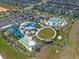 Aerial view of a stunning waterpark with multiple slides, pools, splash pads, and relaxation areas for Gathering fun at 8976 Azalea Sands Ln # 2604, Davenport, FL 33896