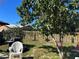 View of backyard featuring wooden fence, tree, grill, and patio furniture at 974 Feather Dr, Deltona, FL 32725