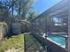 Backyard with view of shed, screened pool, and grass at 974 Feather Dr, Deltona, FL 32725